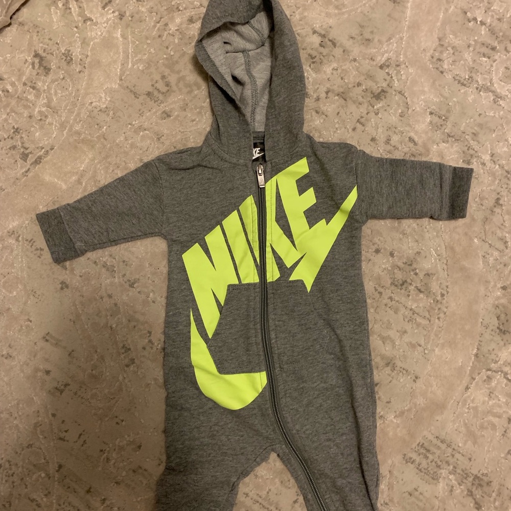 Two Nike onesies
